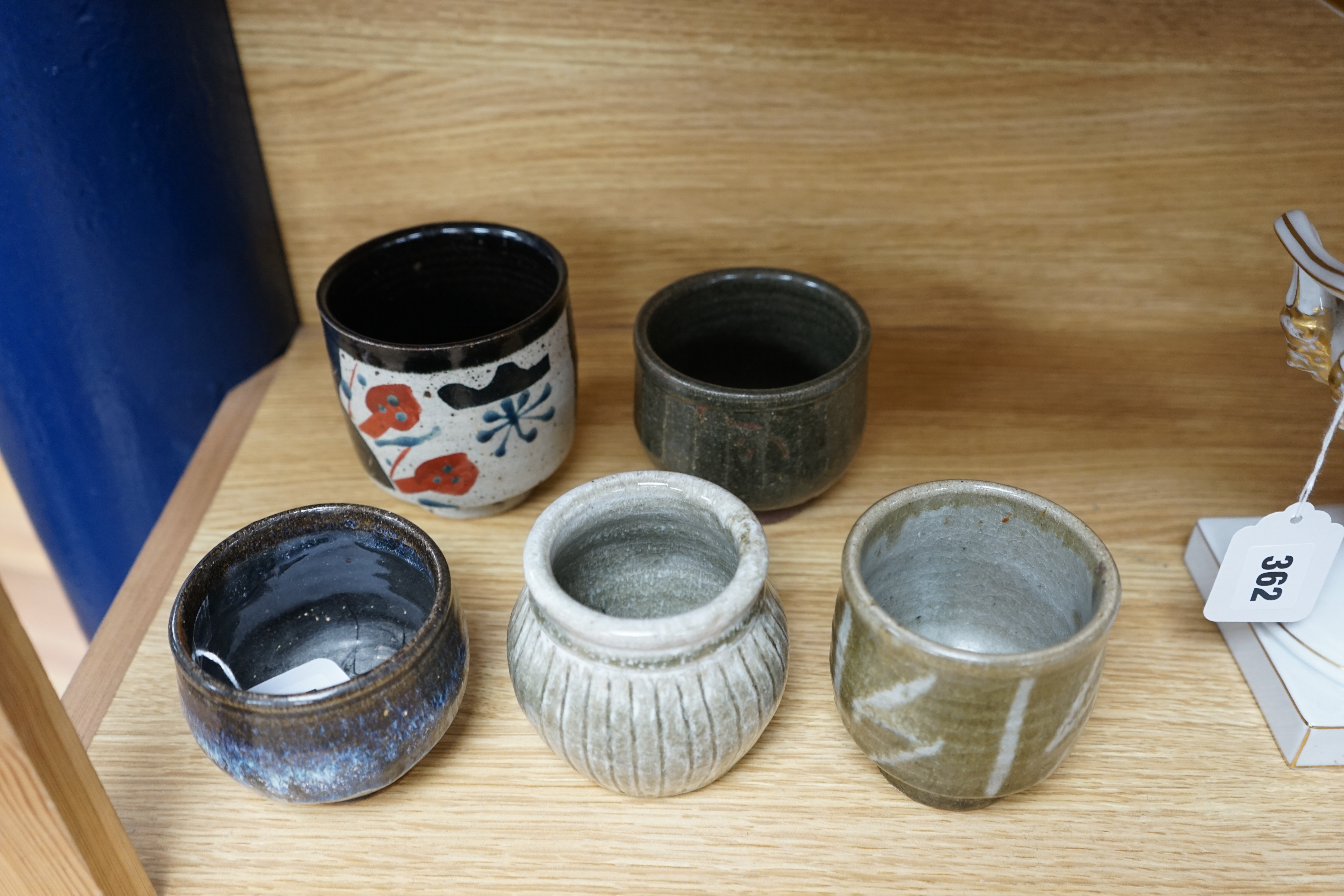 Five Japanese and European studio pottery yunomi, including an example by John Maltby, 10.5cm, together with another signed with a ‘P’ to the base. Condition - good.